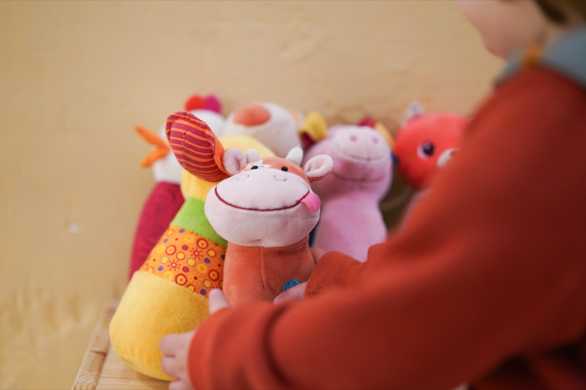 Girl playing with puppets at Tribu House Kids Care childcare service
